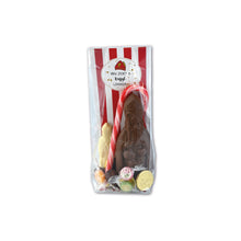 Load image into Gallery viewer, “Transparant pakket met chocolade Sint, witte chocoladefiguur, zuurstok, verpakte snoepjes en chocolademunten.”